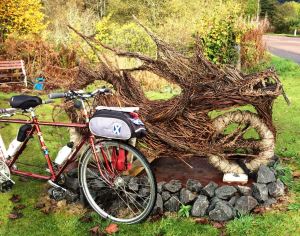 Dragon Bike wooden sculpture - and me - at Lochearnhead.